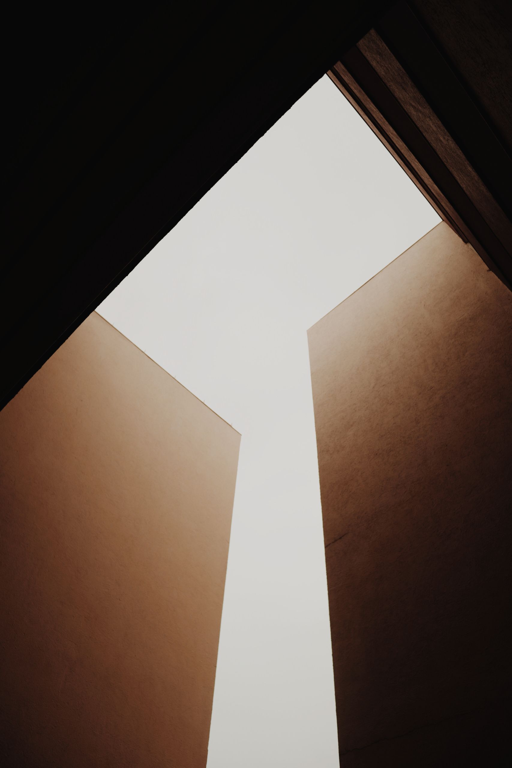 Abstract view of modern architecture showcasing a minimalist sky opening between buildings.